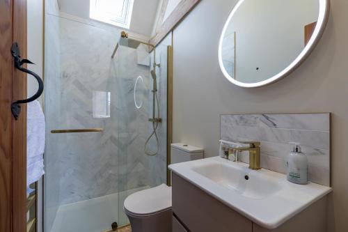a bathroom with a sink and a shower with a mirror at Country Cottage with Hot Tub - pre-heated for your arrival in Buxton