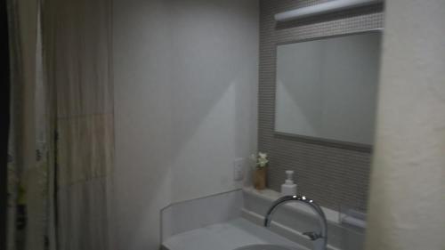 a bathroom with a sink and a mirror at Kikunoya Ryokan in Kanazawa
