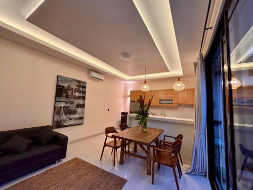 a living room with a table and a couch at Guna Villas in Dalung