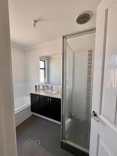 a bathroom with a shower and a sink and a tub at Rooms in Quiet House in Bedford in Perth