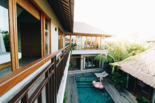 an external view of a house with a swimming pool at ZIN Berawa Villas & Bungalows in Canggu