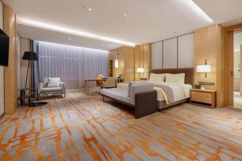 Ένα ή περισσότερα κρεβάτια σε δωμάτιο στο Hui Feng Wan Yun Hotel Hefei