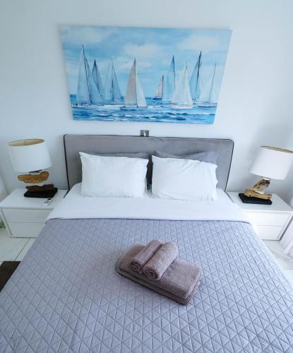 a bed with a towel on it with sailboats on it at Bloom of Luxury in Limassol