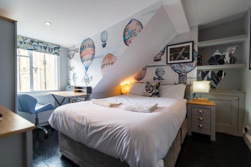 a bedroom with a large bed with white sheets at 6 Bedroom Refurbished Georgian House Close To Sea & Garden Ramsgate in Ramsgate