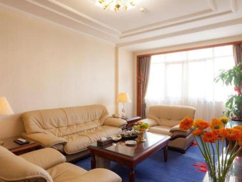 a living room with a couch and a table at Quanzhou Hotel in Quanzhou