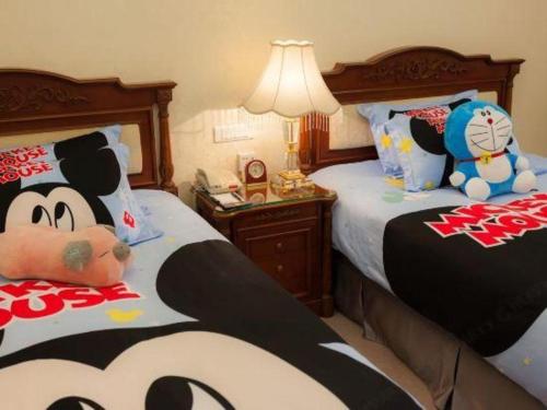 a bedroom with two beds with stuffed animals on them at Quanzhou Hotel in Quanzhou