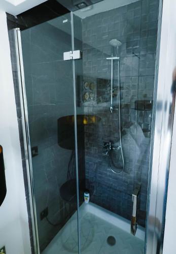 a shower with a glass door in a bathroom at Bloom of Luxury in Limassol