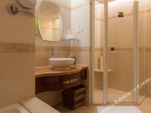 a bathroom with a sink and a shower at Quanzhou Hotel in Quanzhou