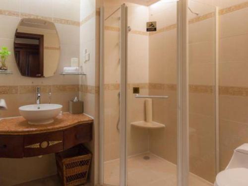 a bathroom with a shower and a sink at Quanzhou Hotel in Quanzhou