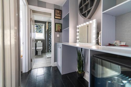 a bathroom with a sink and a toilet at 6 Bedroom Refurbished Georgian House Close To Sea & Garden Ramsgate in Ramsgate