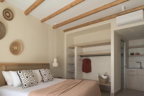 a bedroom with a large bed and a bathroom at Stella in the Village Studios in Plakias