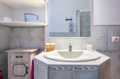 a bathroom with a sink and a mirror at Casa Claudia Le Tonnare Stintino in Stintino
