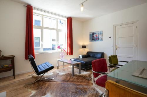 a living room with a couch and a table at logeren in maastricht in Maastricht