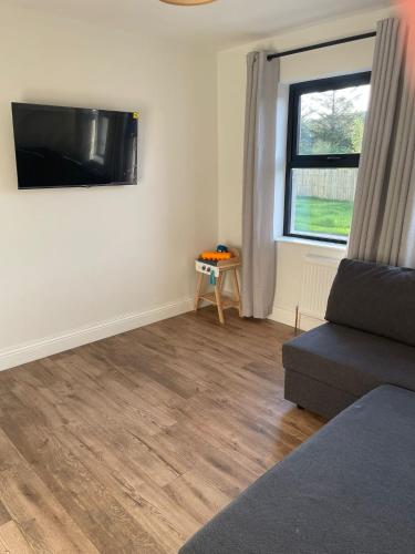a living room with a couch and a window at Teach Annie in Annagry