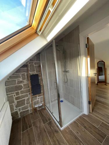 a bathroom with a shower and a window at Teach Annie in Annagry