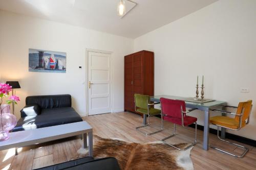 a living room with a table and chairs at logeren in maastricht in Maastricht