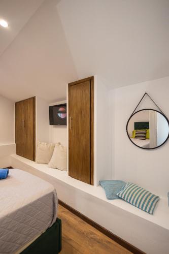 a bedroom with a bed and a mirror on the wall at Artemis House Corfu Town in Ágios Rókkos
