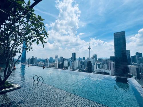 a swimming pool on top of a city skyline at The KLCC Suites At Axon Residence in Kuala Lumpur