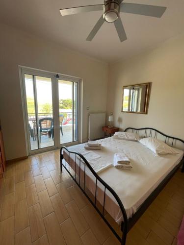 a bedroom with a bed with a ceiling fan at Villa Diapori in Tsimándria