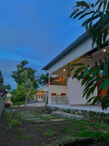 a modern house with white walls at Iza home stay in Senaru