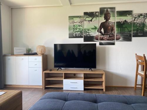 a living room with a television on a table at Haus Kampl - Appartement Grundlsee in Bad Mitterndorf
