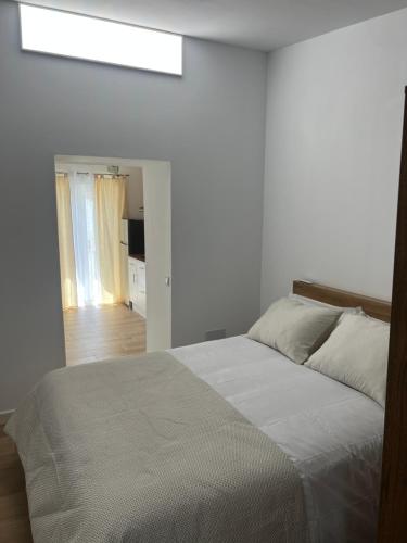 a bedroom with a bed and a skylight at Casa Roberto in Alora