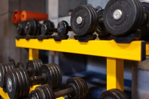 a row of dumbbells on a yellow shelf at R73 Residences in Pécs