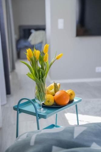a table with a vase of flowers and fruit on it at Rahukodu in Kõrgessaare