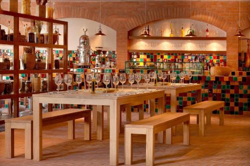 a room with a table with wine glasses on it at The Westin Resort, Costa Navarino in Romanós