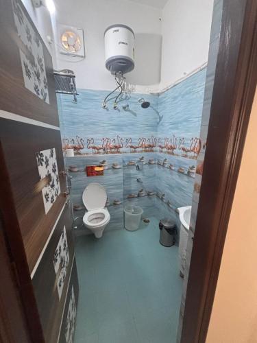 a bathroom with a toilet and a sink at Krishnabalram wellness & Ayurveda centre in Rishīkesh