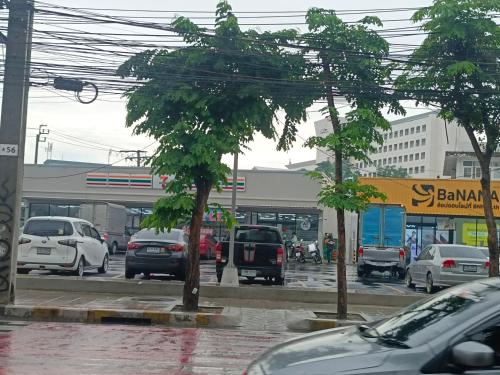 a busy city street with cars parked in a parking lot at The little home in Bangkok