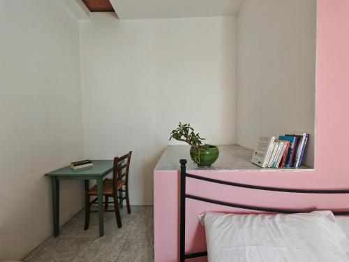 a bedroom with a desk and a table with a chair at Sa Posada in Cuglieri