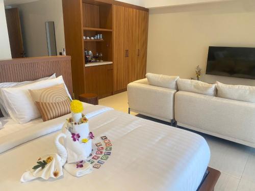 a hotel room with a swan on a bed at Baan Bophut Beach Hotel Samui - SHA Extra Plus in Bophut 
