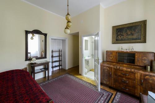a bathroom with a wooden dresser and a mirror at La Vecchia Casa in Cetinje