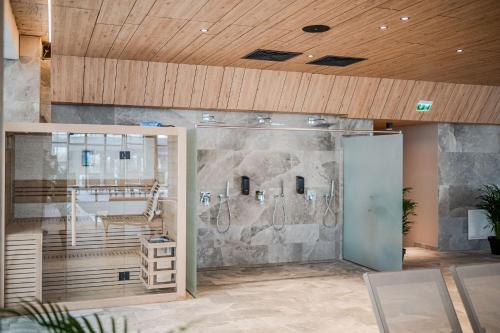 a room with a stone wall and a glass door at Erato Apartment in Odyssey Spa Pool & Fitness Resort-parking in Mamaia
