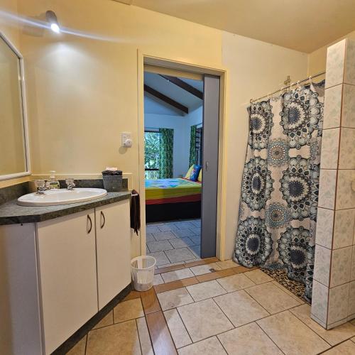 a bathroom with a sink and a shower at Mango Cottage with AC, Unlimited Wifi and Private pool in Rarotonga