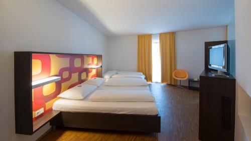 Posteľ alebo postele v izbe v ubytovaní arte Hotel Krems