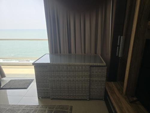 a large wicker basket sitting in front of a window at Beach Front Apartment in Uswetakeiyawa