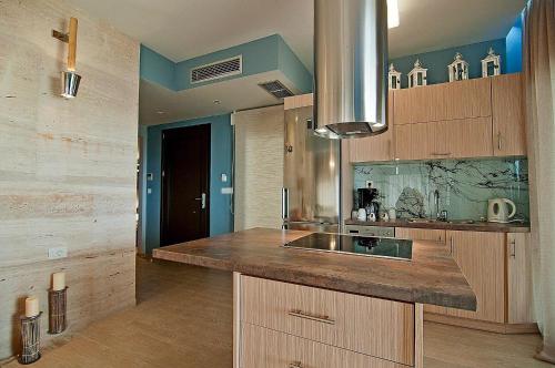 a kitchen with wooden cabinets and a counter top at Christie's Luxury Suites by Dandy Hospitality in Syvota