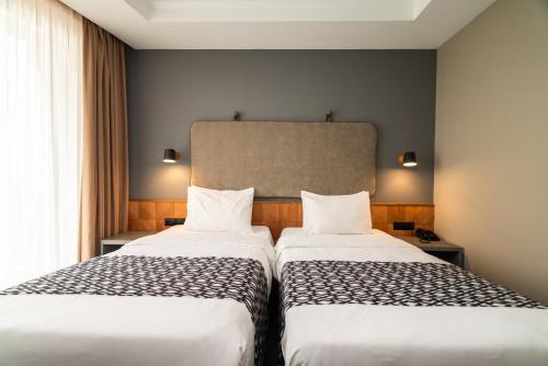 two beds sitting next to each other in a room at Amante Narikala Boutique Hotel in Tbilisi City