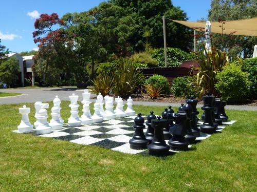 a giant chessboard on the grass in a yard at Ramada Resort By Wyndham Rotorua Marama in Rotorua