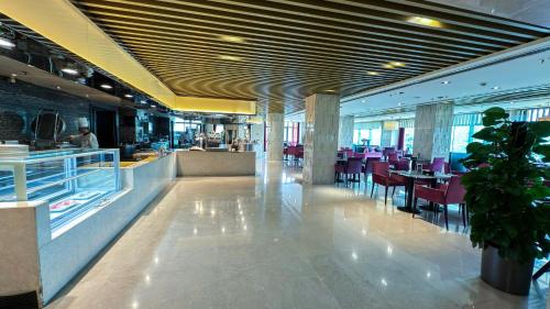 a dining room with tables and chairs in a restaurant at YANJING Hotel 北京燕京饭店 in Beijing