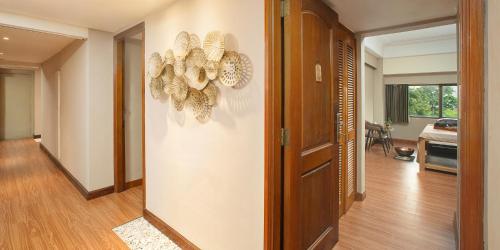 a hallway with a door to a room with at Aryaduta Menteng in Jakarta
