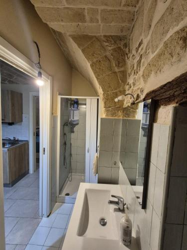 a bathroom with a sink and a shower at futura home centro storico 5 minuti da Bari in Modugno