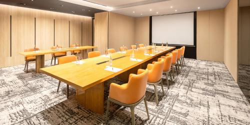 a conference room with a long table and chairs at Aryaduta Menteng in Jakarta