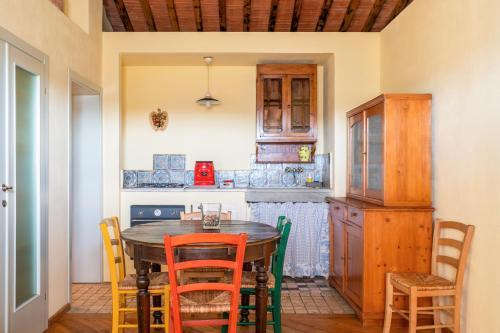 a kitchen with a wooden table and chairs at Alpaca country house in Pontedera