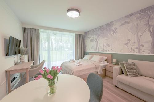 a hotel room with a bed and a table at Apartamenty Florina Q4Apartments in Łeba