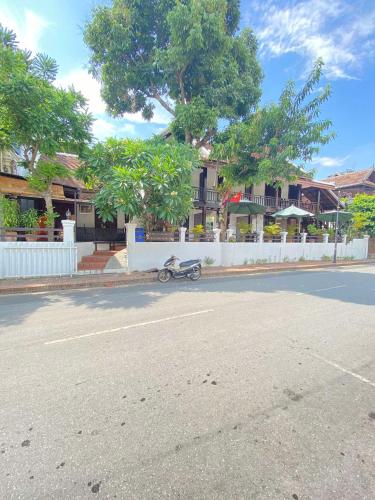 a motorcycle parked on the side of a street at Luang Prabang Golden Lotus Villa River View in Luang Prabang