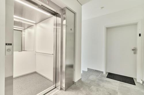 a hallway with a metal elevator and a door at ELA Apartments Mannheim in Mannheim