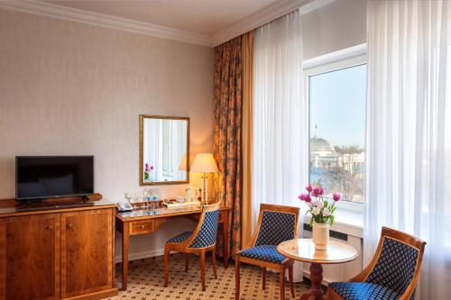 a hotel room with a desk and a window at Natsionalny Hotel in Kyiv